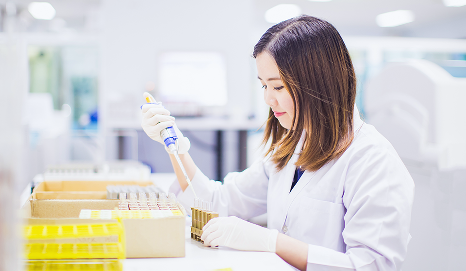 Woman looking into test tube