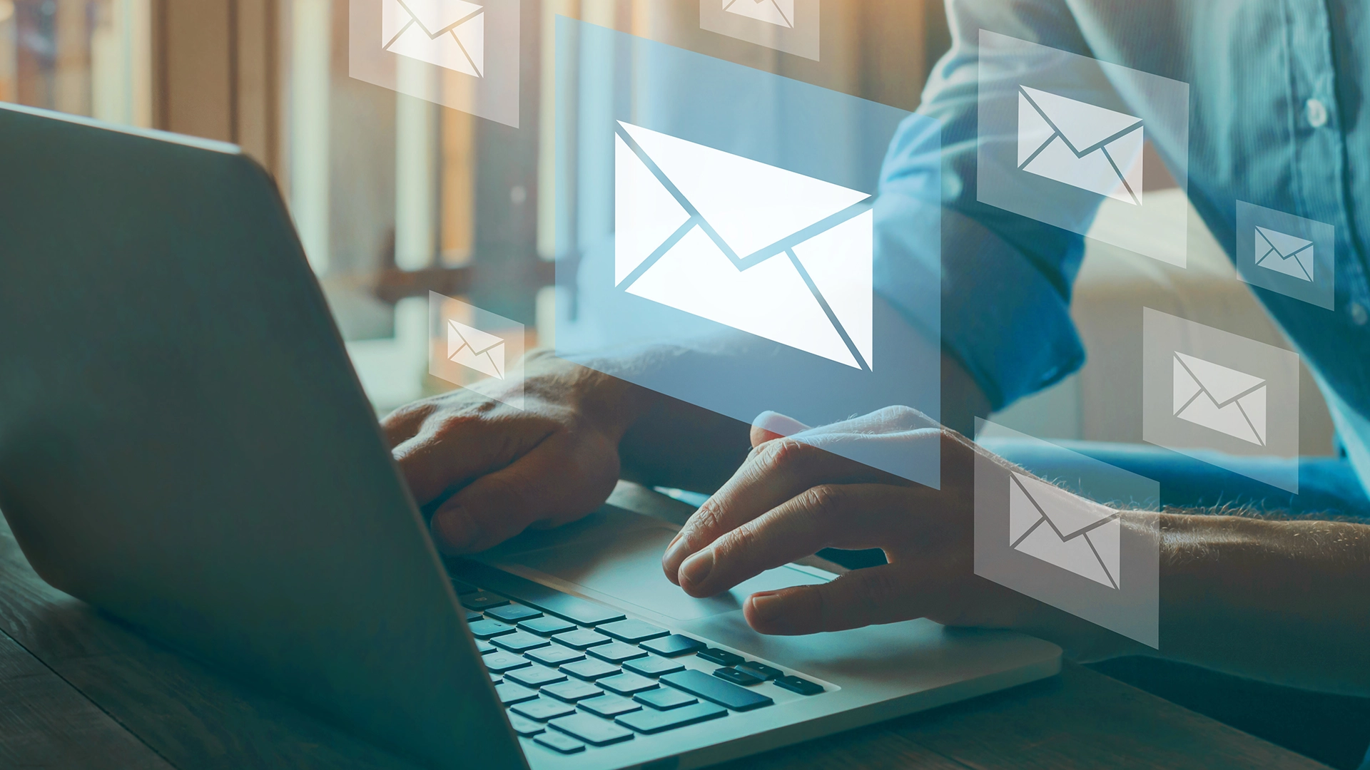 Man at computer receiving emails.